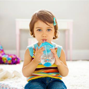 A toddler using a click-lock cup