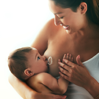 Woman breastfeeding a baby with Flow Nipple Shield +